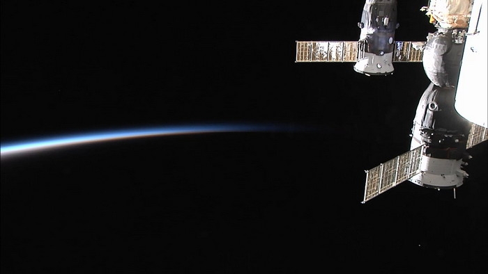 Dawn on the ISS. In the right part of the picture manned spacecraft