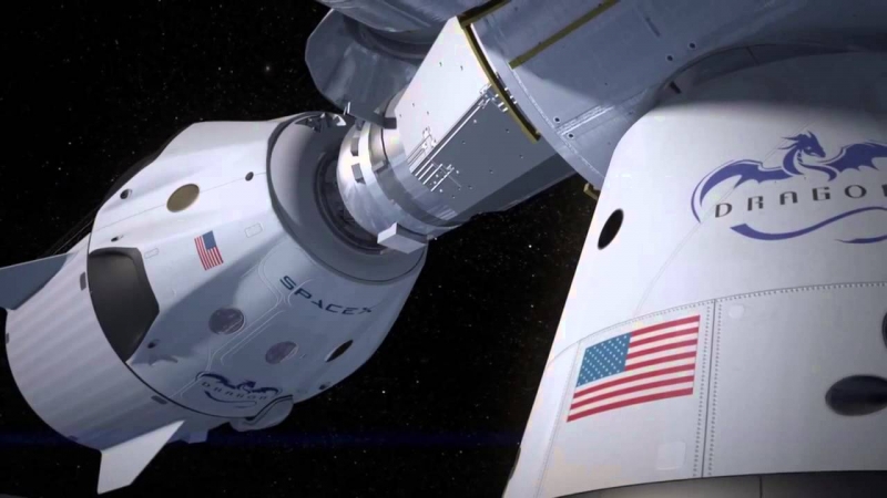  Пилотируемый Dragon V2 и грузовой Dragon, пристыкованные к МКС в представлении художника (графика SpaceX) 